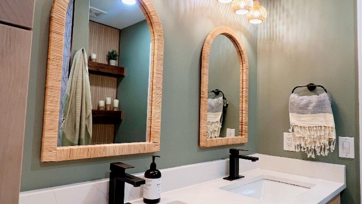 home renovation near Cornelius, NC featuring renovated bathroom with large white vanity, light wood accents, and sage green walls.