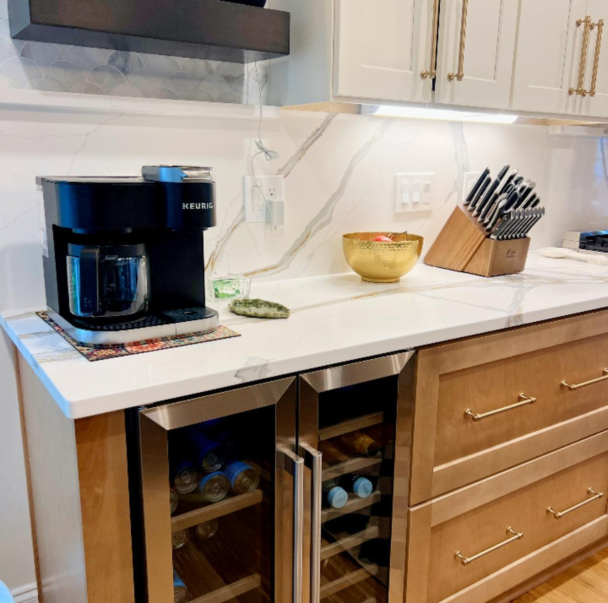 beverage bar featuring coffee maker with open shelving above. wine fridge under the countertop