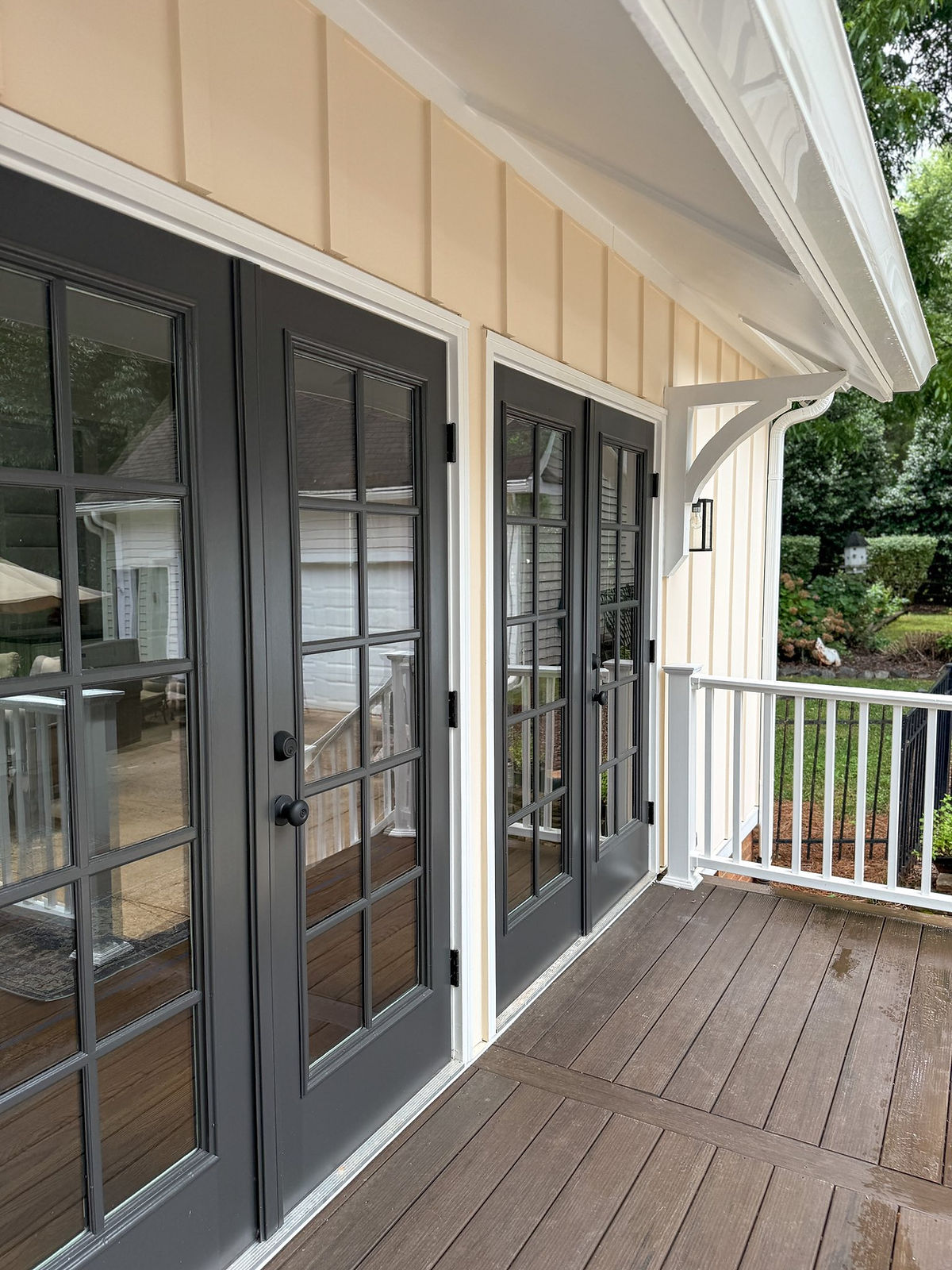 home addition near Huntersville, NC featuring board and batten siding and french doors out onto a deck.