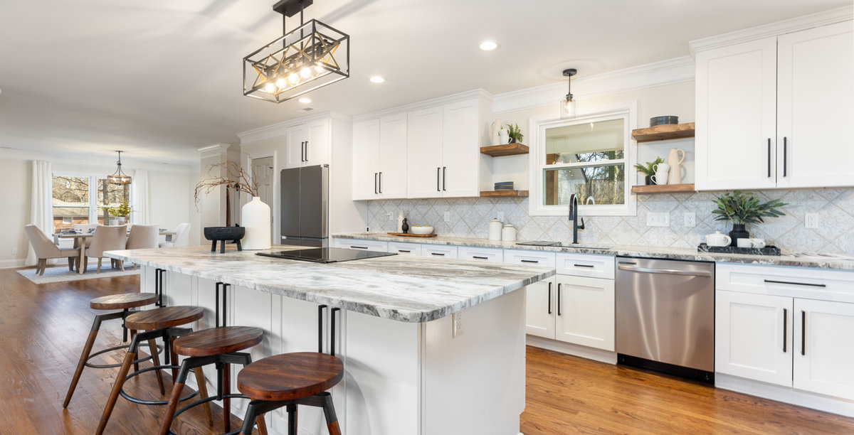 Renovated Kitchen with granite counters, white countertops, and hardwood floors