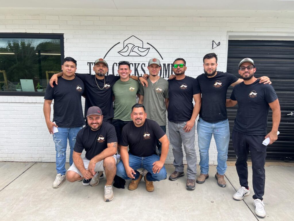 A group photo of the Two Chicks Homes renovation team