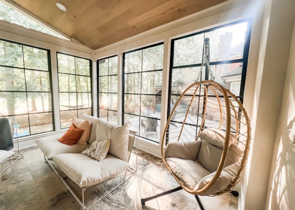 sunroom with wood ceiling and suspended egg chair is a picture of luxury living spaces in Huntersville NC