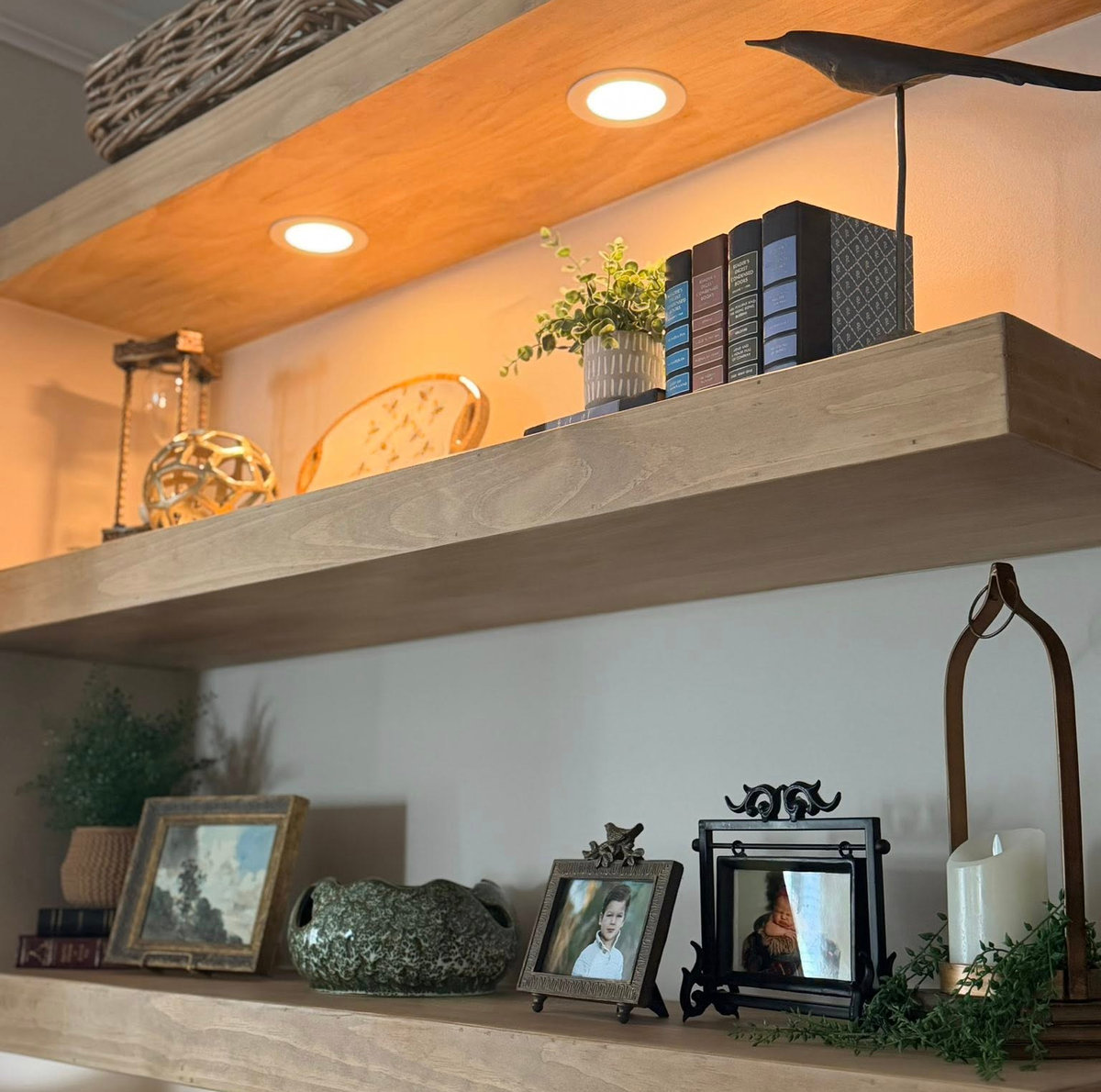 open wood shelving with built in down lights to illuminate books and plants, etc