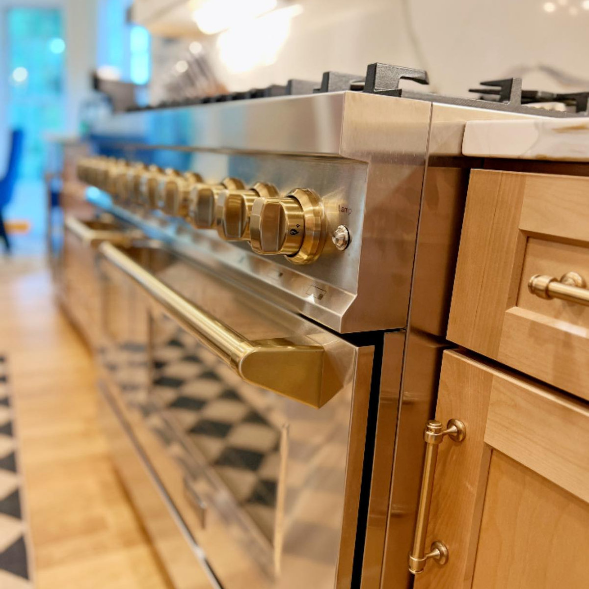 close up on modern stainless steel oven with gold accents on the knobs