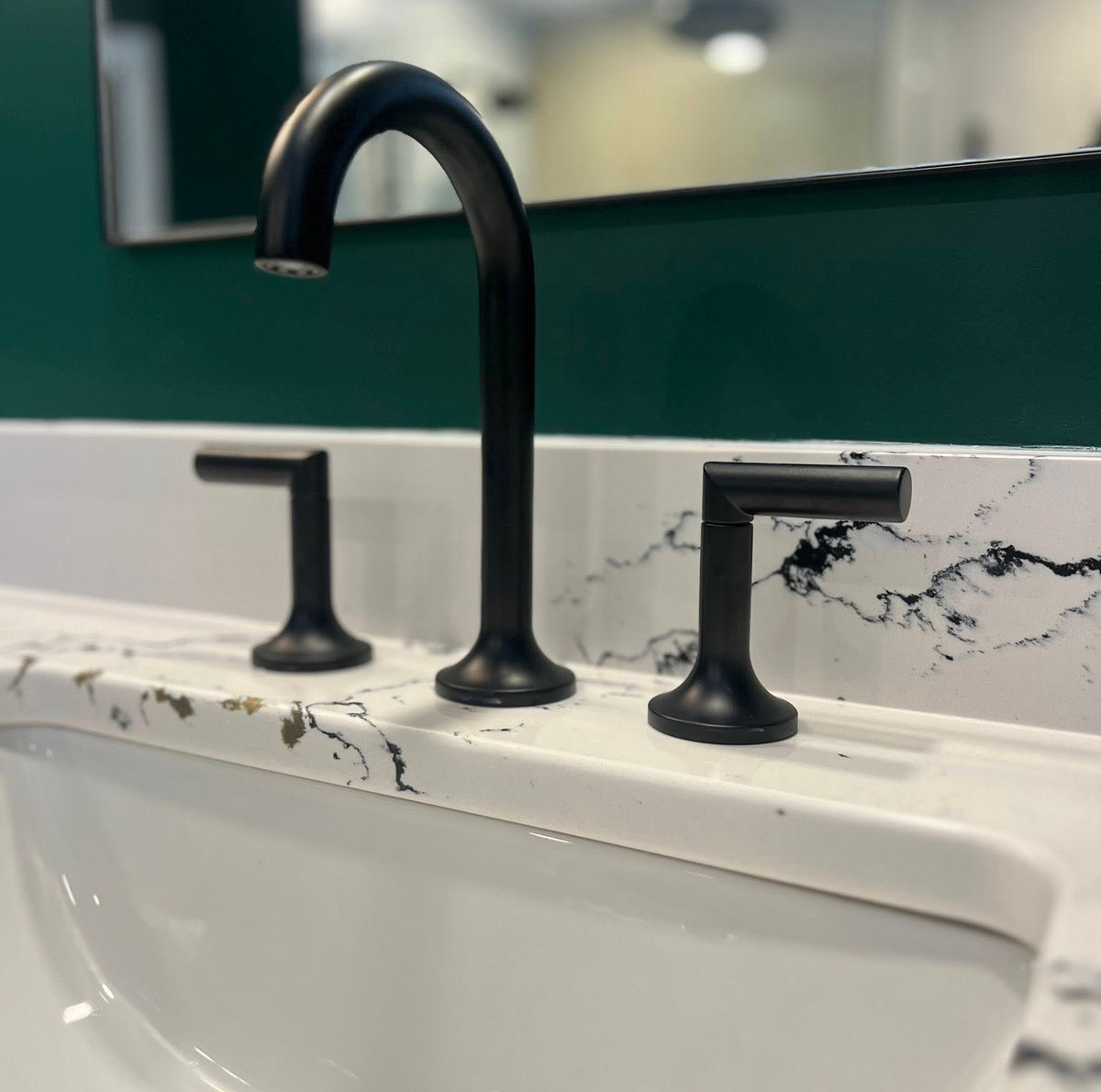 stone countertop with black veining and black sink faucet