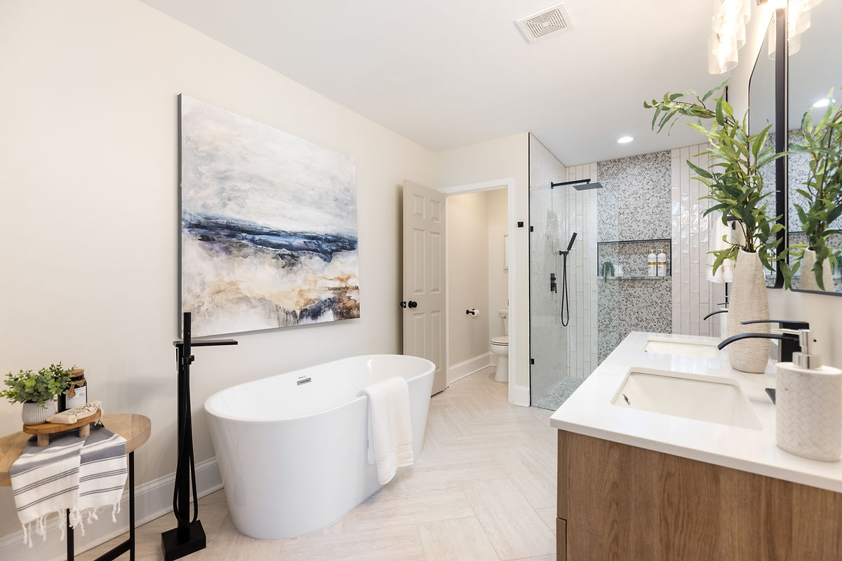 home remodel near Cornelius NC featuring a bright clean bathroom with tiled flooring, and a soaking tub.