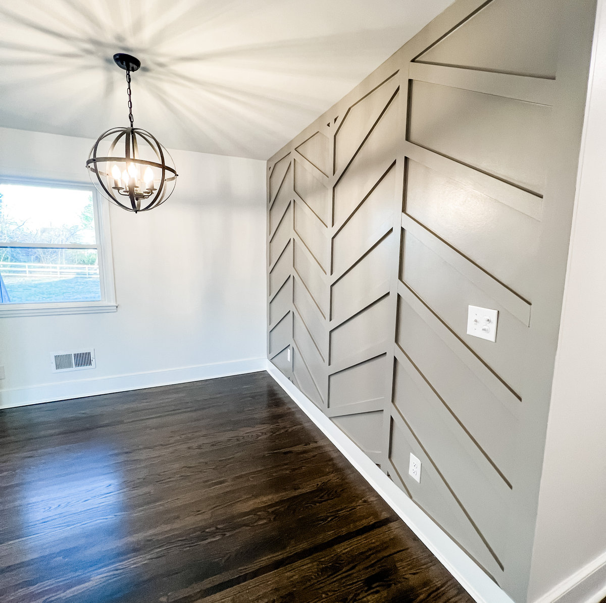 home renovation near Huntersville NC featuring a gray herringbone accent wall and farmhouse light fixture