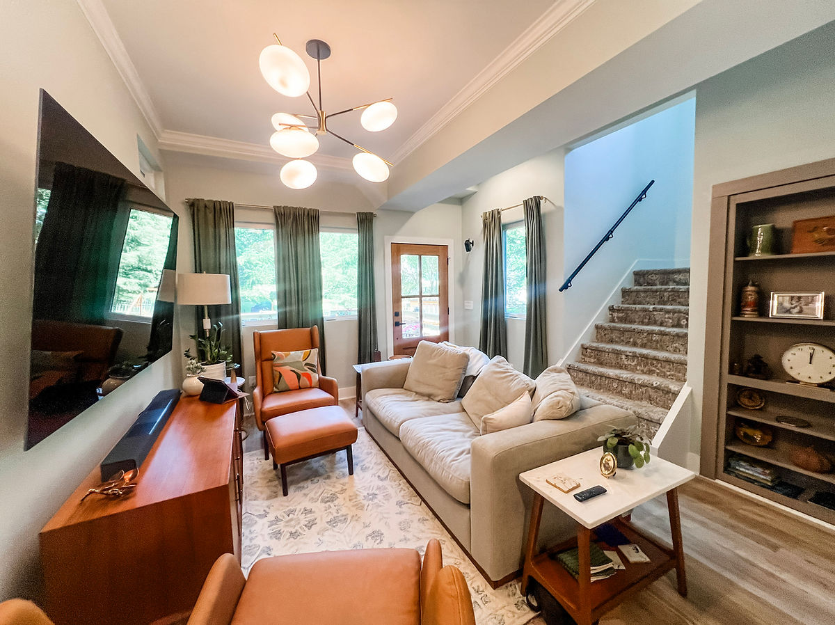 home renovation near Davidson, NC featuring an open living space with built ins, hardwood floors, and fresh light walls