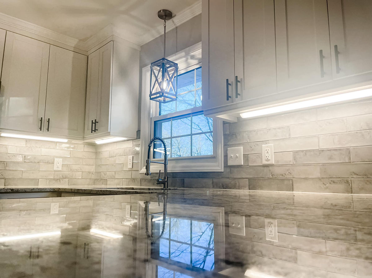renovated kitchen with shiny granite countertops