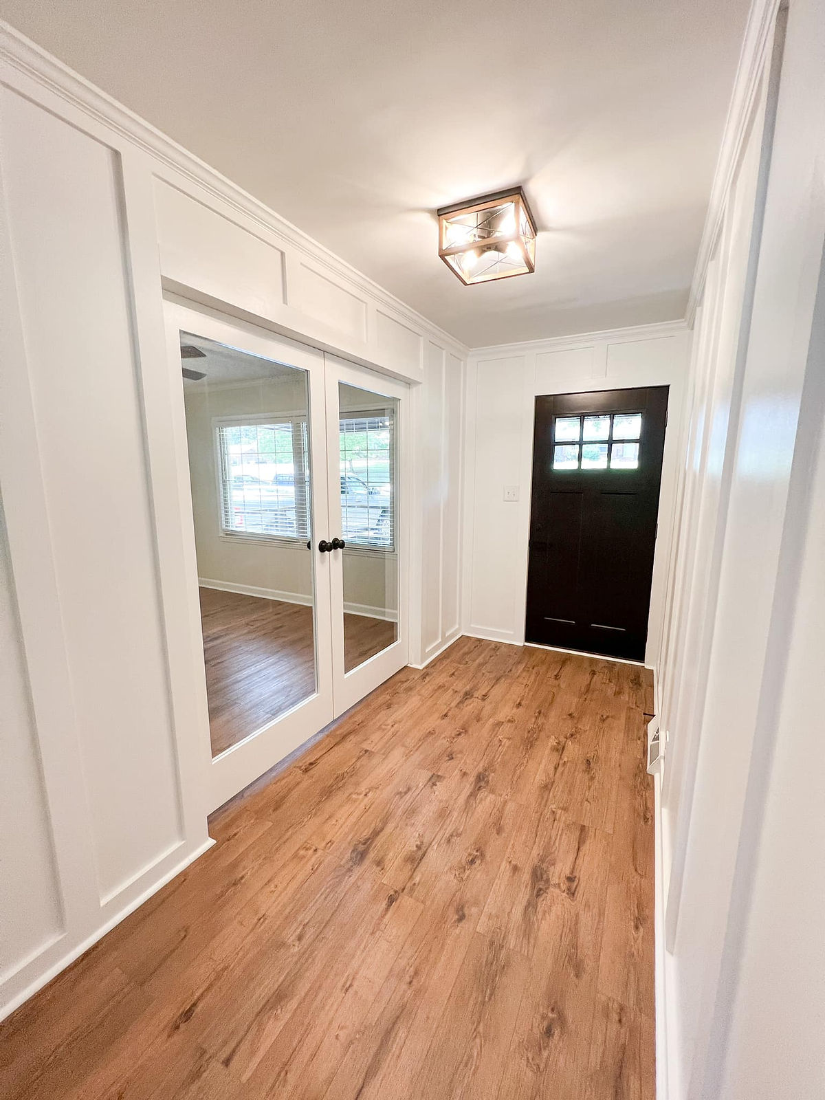 home remodel near Huntersville NC. Entry way features hardwood flooring and fresh white paint