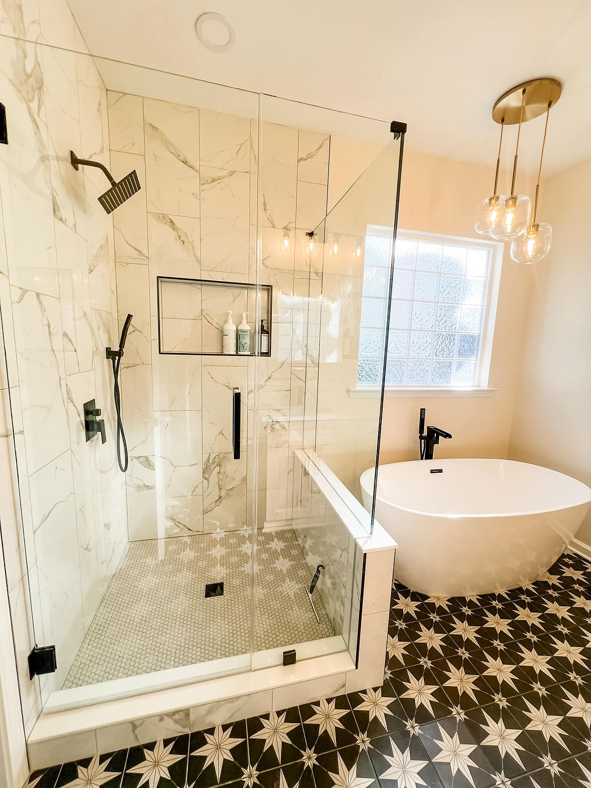 home renovation near Cornelius, NC featuring renovated bathroom with marble tile shower, soaking tub, and painted concrete look tile flooring