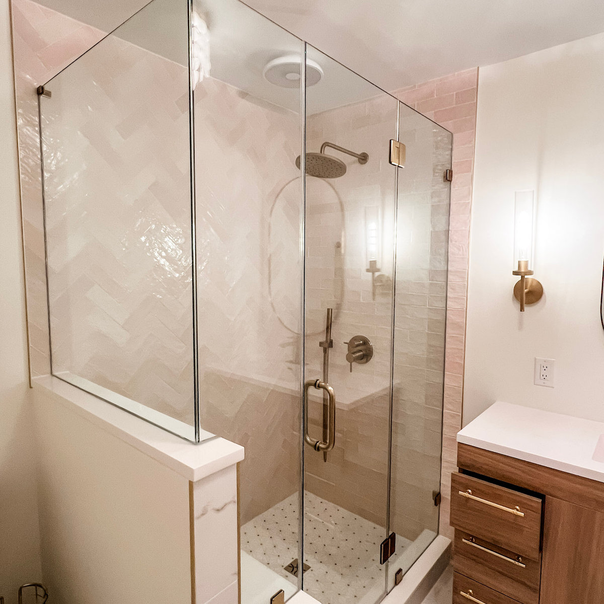 light pink tiled shower with glass walls and door