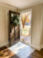 open front door with a festive green wreath