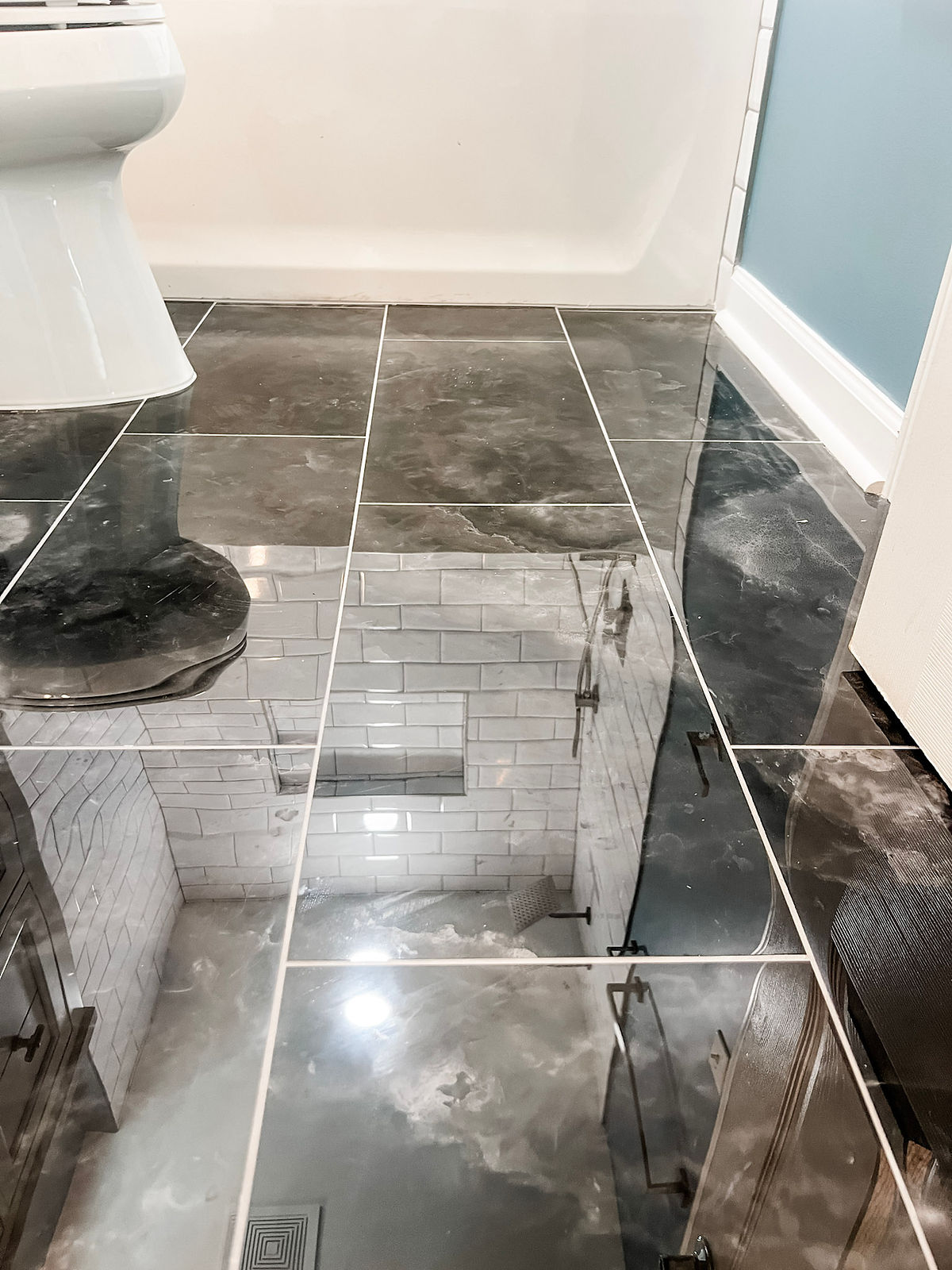 high shine black marble tile flooring in a bathroom home renovation near Davidson. NC