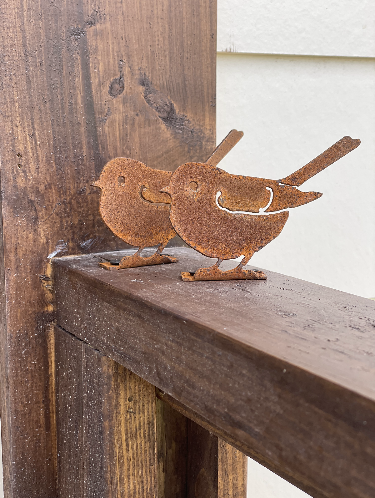 porch rail featuring metal cut out of two chicks