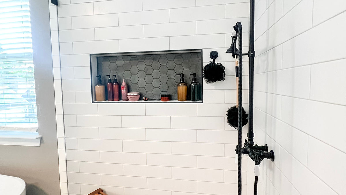 Home renovation near Davidson, NC renovated bathroom with white subway tile shower and black fixtures