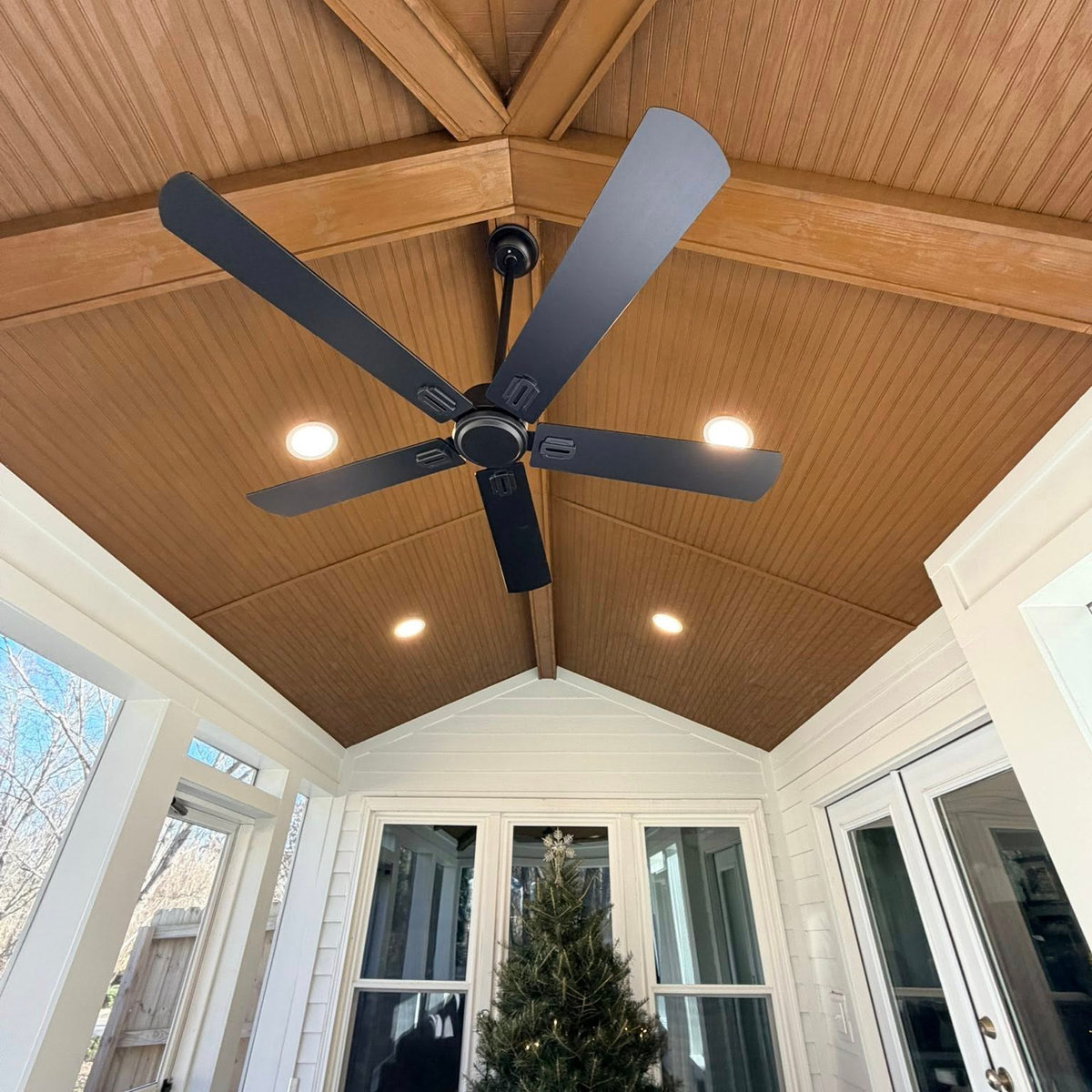 all season porch featuring a wooden ceiling with can lightfixtures and a dark ceiling fan