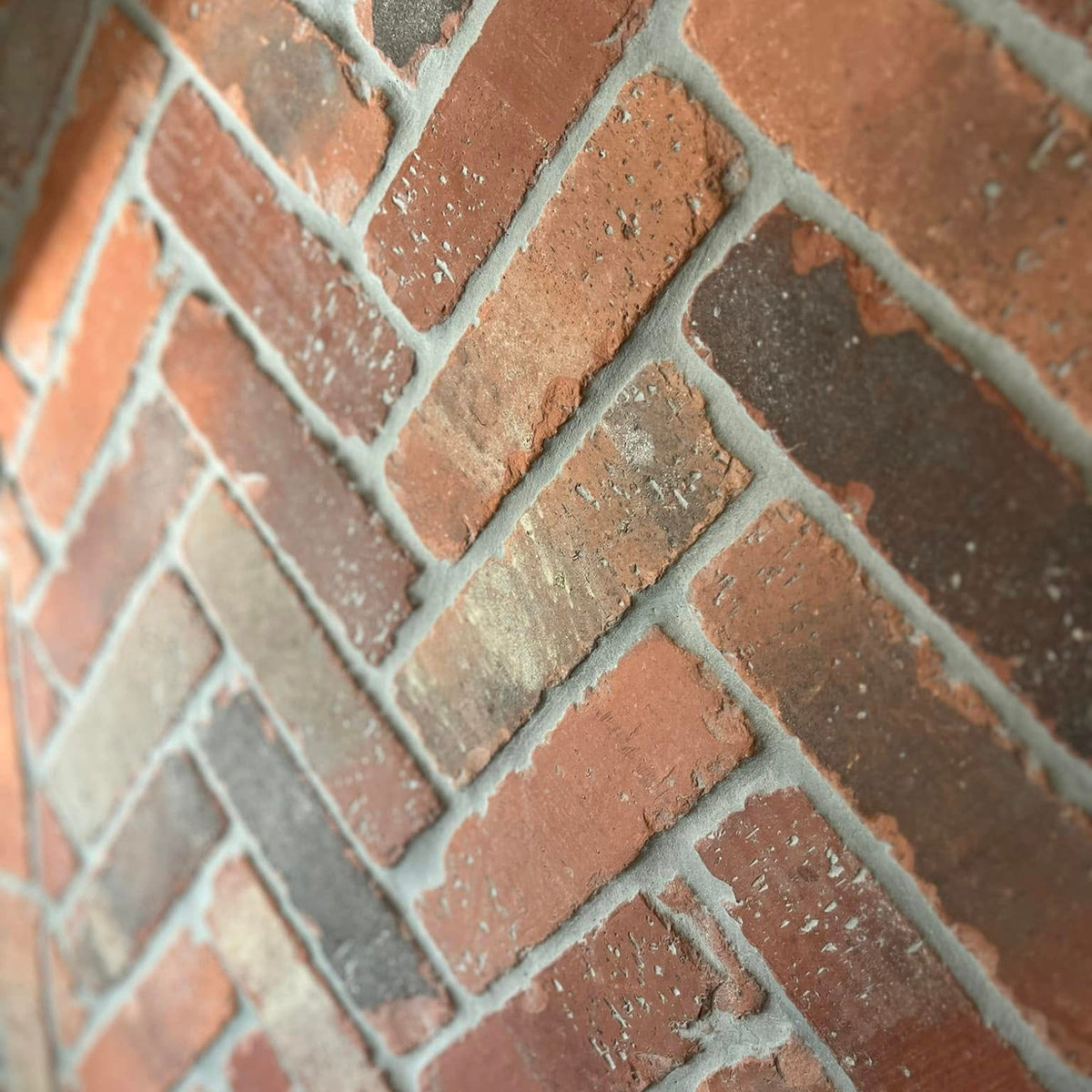 close up textured brick herringbone wall