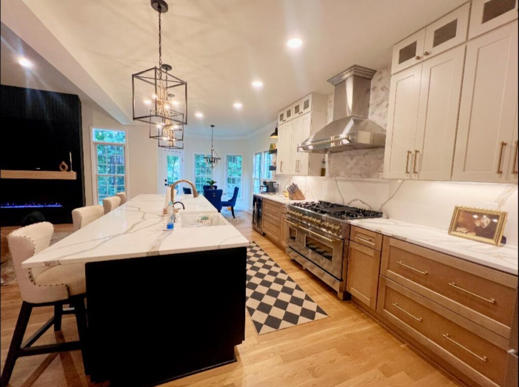 functional luxury renovation near Davidson, NC featuring new kitchen with stone backsplash, white cabinetry, and stainless steel range hood