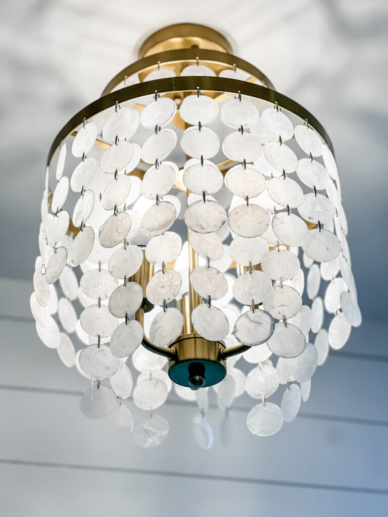 home renovation davidson NC featuring fun gold and white tiered chandelier on a white ceiling
