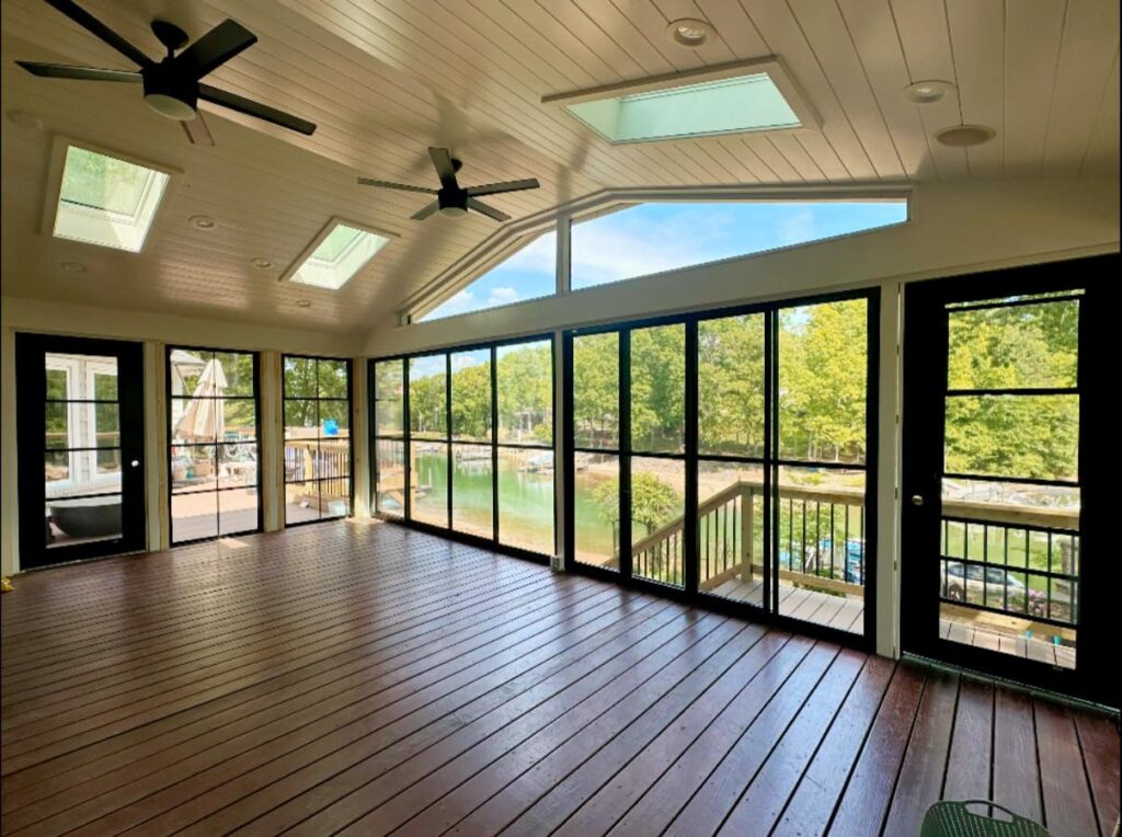 porch renovation project with large windows and glass all around looking out into a lake and woods. Great example of bright home interior cornelius NC.