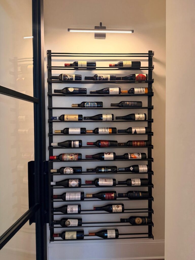 custom home renovation in huntersville, NC featuring a walk in wine cellar with lit display rack.